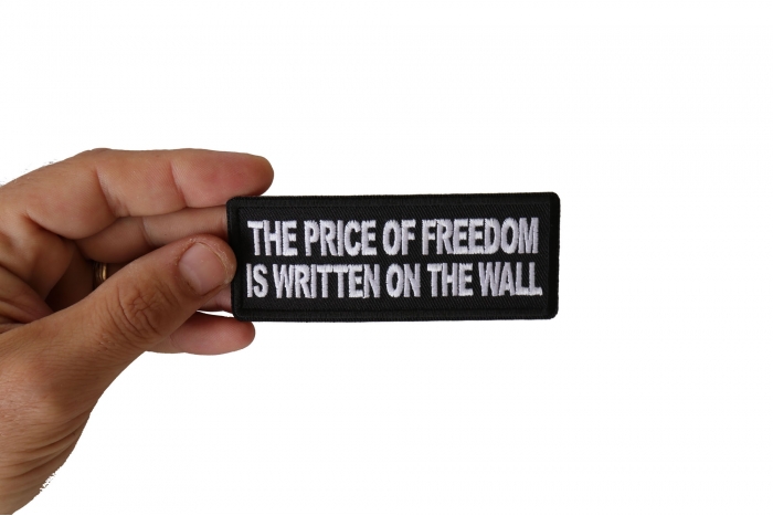 The Price of Freedom is Written on The Wall Patch, Military Saying Patches shown on hand for size comparison