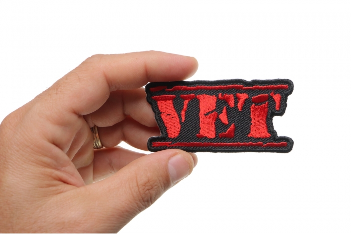 Vet Patch Old Stamper Red shown on hand for size comparison