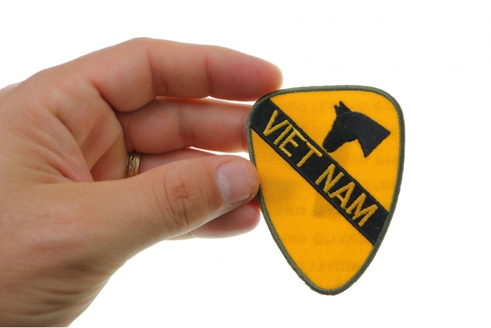 Vietnam 1st Cavalry Patch shown on hand for size comparison