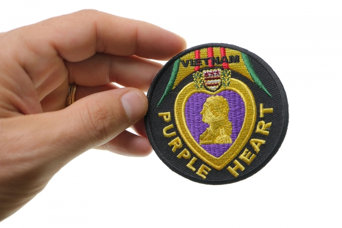Vietnam Purple Heart Patch shown on hand for size comparison
