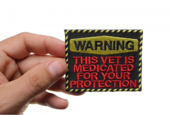 Warning: This Vet Is Medicated For Your Protection Patch shown on hand for size comparison