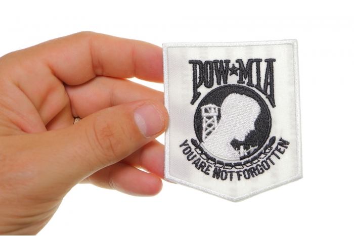 White POW MIA Iron on Patch shown on hand for size comparison