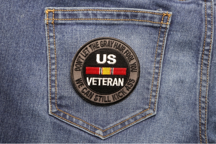 Don't Let The Gray Hair Fool You We Can Still Kick Ass US VETERAN Patch shown on jeans