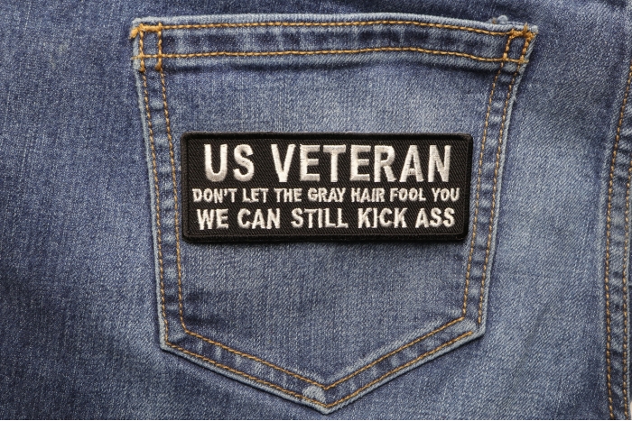 US VETERAN Don't Let the Gray Hair Fool You We Can Still Kick Ass Patch shown on jeans