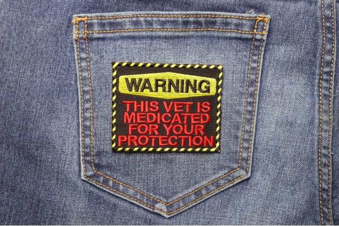 Warning: This Vet Is Medicated For Your Protection Patch shown on jeans