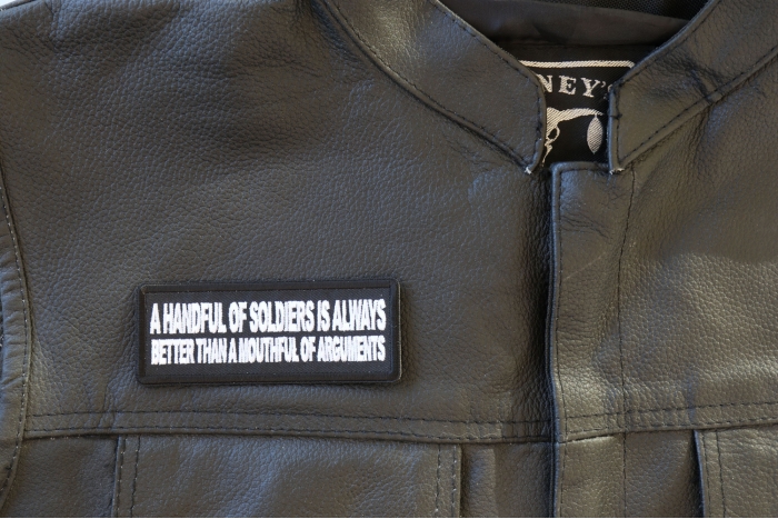 A Handful of Soldiers is Always Better than a Mouthful of Arguments Patch - 4x1.5 inch - Embroidered Iron on Patch shown on leather vest