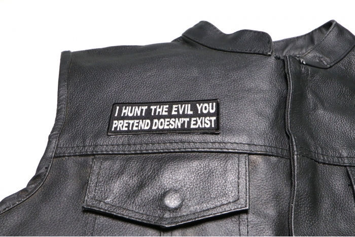 I Hunt The Evil You Pretend Doesn't Exist Patch - 4x1.5 inch. Embroidered Iron on Patch shown on leather vest
