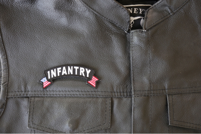 Infantry Small Flag Rocker Patch - 4x1.5 inch - Embroidered Iron on Patch shown on leather vest