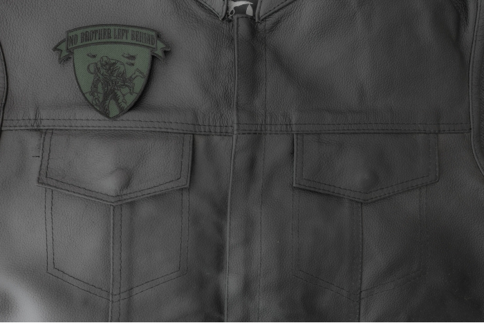 No Brother Left Behind Small Patch In Green Black - 4.5x3.5 inch. Embroidered Iron on Patch shown on leather vest