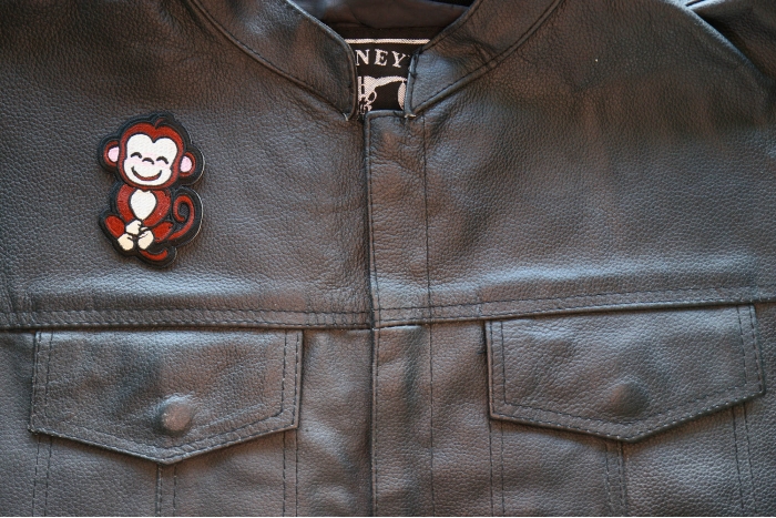 Cute Monkey Iron on Patch shown on leather vest