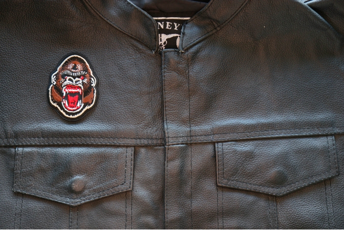 Ugly Monkey Iron on Patch shown on leather vest