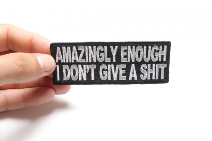 Amazingly Enough I Don't Give A Shit Funny Naughty Patch shown on hand for size comparison
