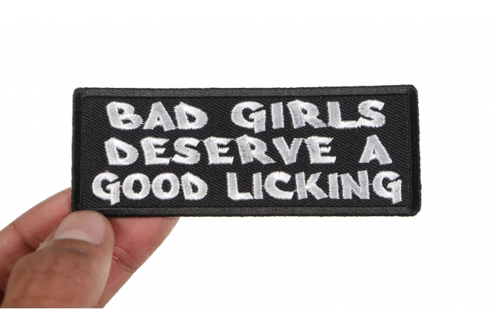 Bad Girls Deserve a Good Licking Naughty Patch shown on hand for size comparison