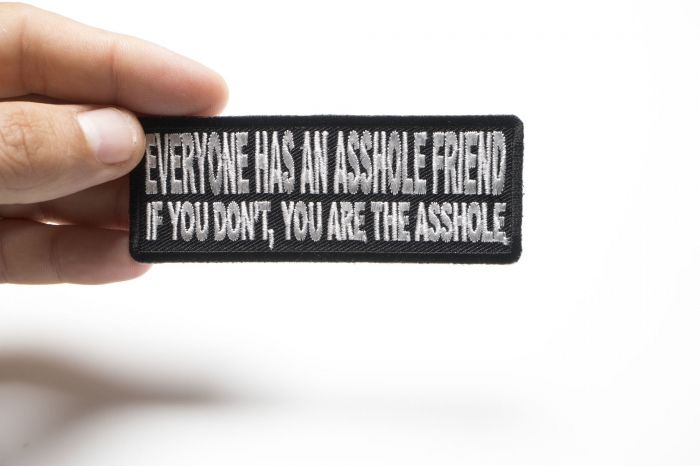 Everyone Has An Asshole Friend If You Don't You Are The Asshole Naughty Iron on Patch shown on hand for size comparison