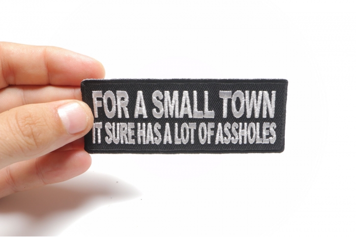 For A Small Town It Sure Has A Lot Of Assholes Naughty Iron on Patch shown on hand for size comparison