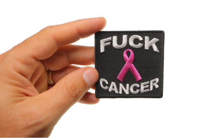 Fuck Cancer Naughty Iron on Patch shown on hand for size comparison