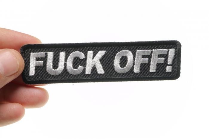 Fuck Off Naughty Iron on Patch shown on hand for size comparison