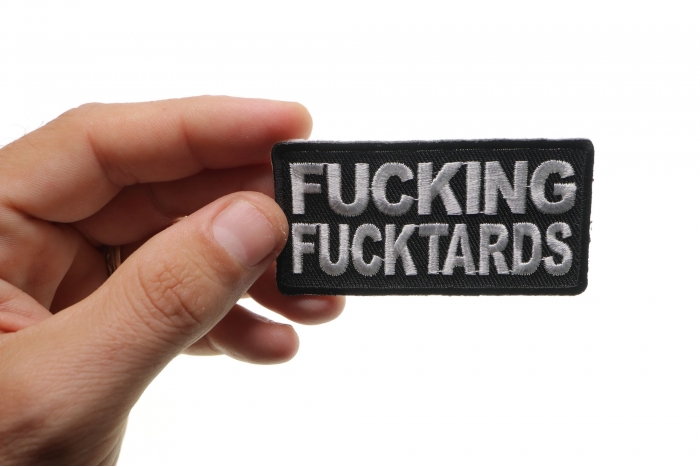 Fucking Fucktards Naughty Iron on Patch shown on hand for size comparison