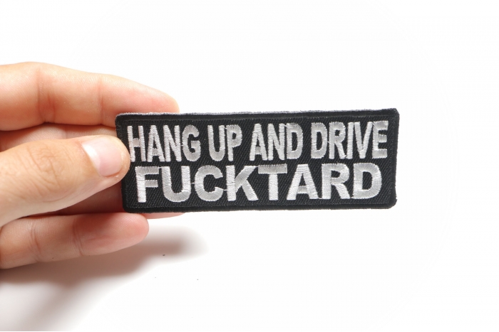 Hang Up and Drive Fucktard Naughty Iron on Patch shown on hand for size comparison