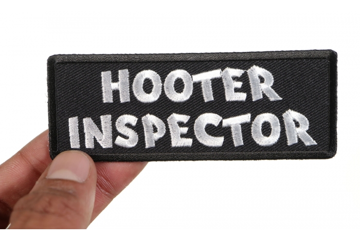 Hooter Inspector Naughty Iron on Patch shown on hand for size comparison