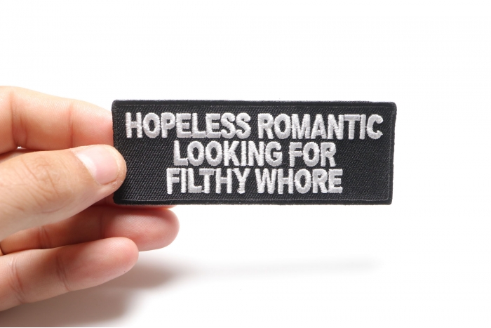 Hopeless Romantic Looking For Filthy Whore Naughty Iron on Patch shown on hand for size comparison
