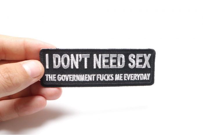 I Don't Need Sex Government Fucks Me Daily Naughty Iron on Patch shown on hand for size comparison