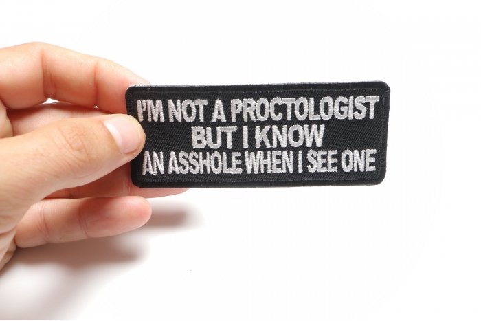 I'm Not A Proctologist But I Know An Asshole When I See One Patch shown on hand for size comparison