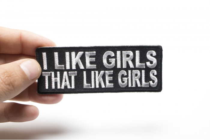 I Like Girls That Like Girls Naughty Iron on Patch shown on hand for size comparison