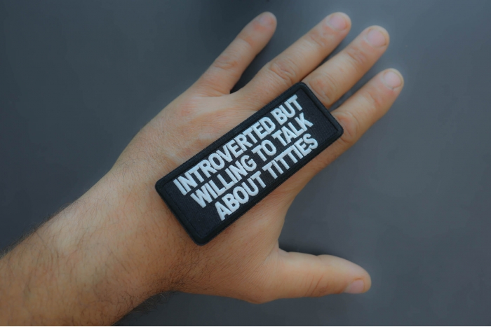 Introverted but willing to talk about titties patch shown on hand for size comparison