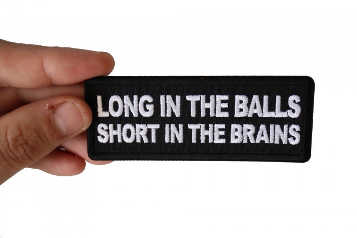 Long in the Balls Short in the Brains Funny Iron on Patch shown on hand for size comparison