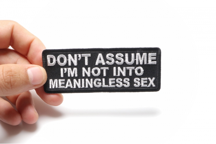Don't Assume I'm Not Into Meaningless Sex Funny Iron on Patch shown on hand for size comparison