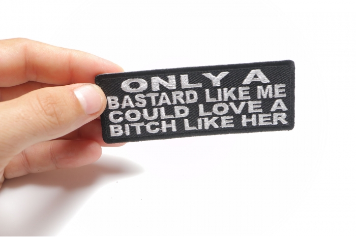Only A Bastard Like Me Could Love A Bitch Like Her Patch shown on hand for size comparison