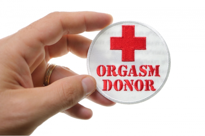 Orgasm Donor Medic Cross Patch shown on hand for size comparison
