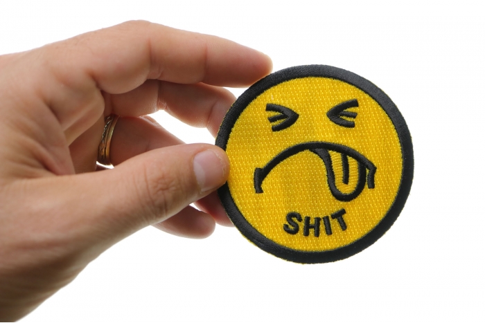 Shit Smiley Face Patch shown on hand for size comparison