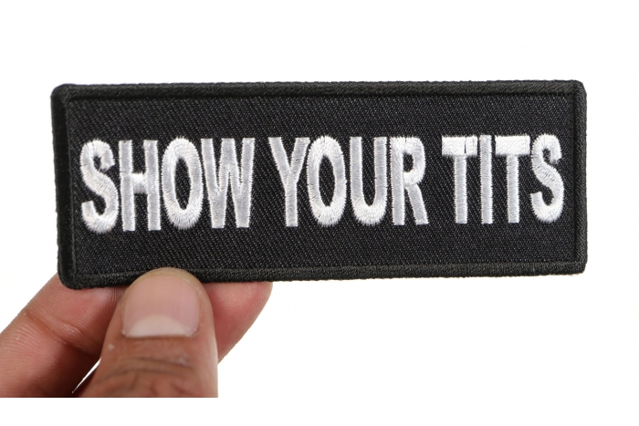 Show Your Tits Patch shown on hand for size comparison