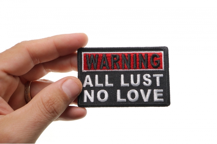 Warning All Lust No Love Patch shown on hand for size comparison