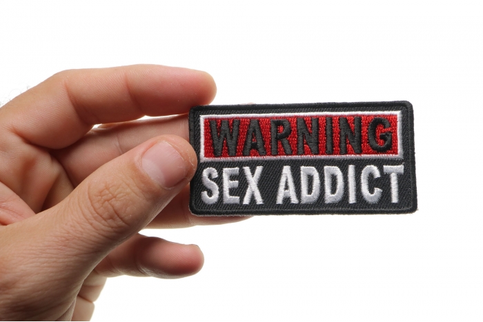 Warning Sex Addict Patch shown on hand for size comparison