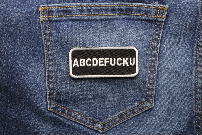 Abcdefucku Patch shown on jeans