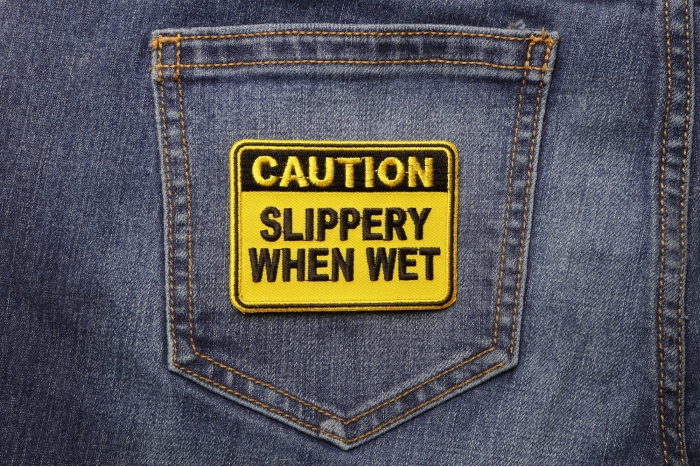 Caution Slippery When Wet Patch shown on jeans