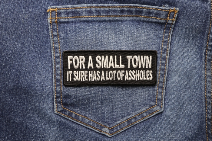 For A Small Town It Sure Has A Lot Of Assholes Naughty Iron on Patch shown on jeans
