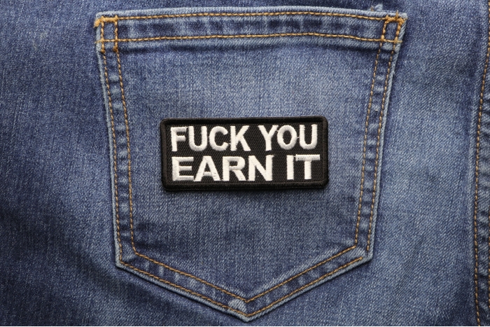 Fuck You Earn It Offensive Iron on Patch shown on jeans