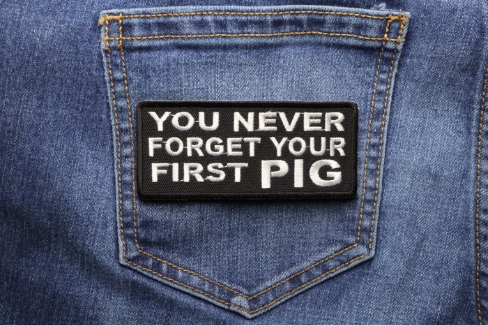 Never Forget First Pig Patch shown on jeans