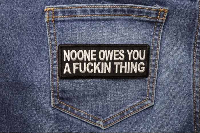 Noone Owes You a Fucking Thing Patch shown on jeans