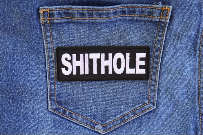 Shithole Funny Iron on Patch shown on jeans