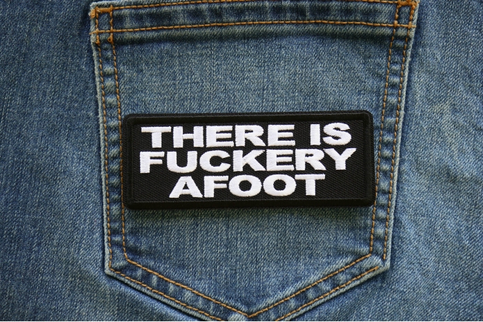 There is a Fuckery Afoot Iron on Patch shown on jeans