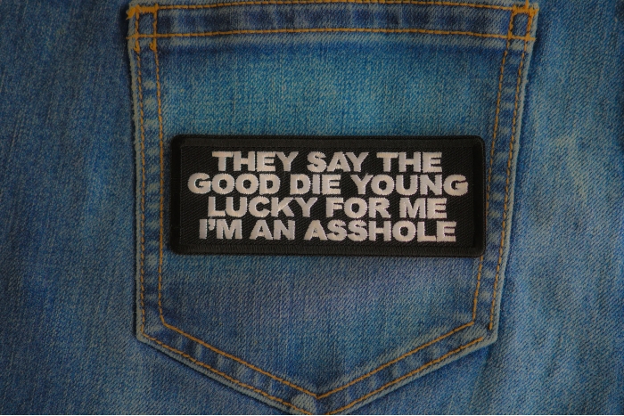 They Say The Good Die Young Lucky For Me I'm An Asshole Patch shown on jeans