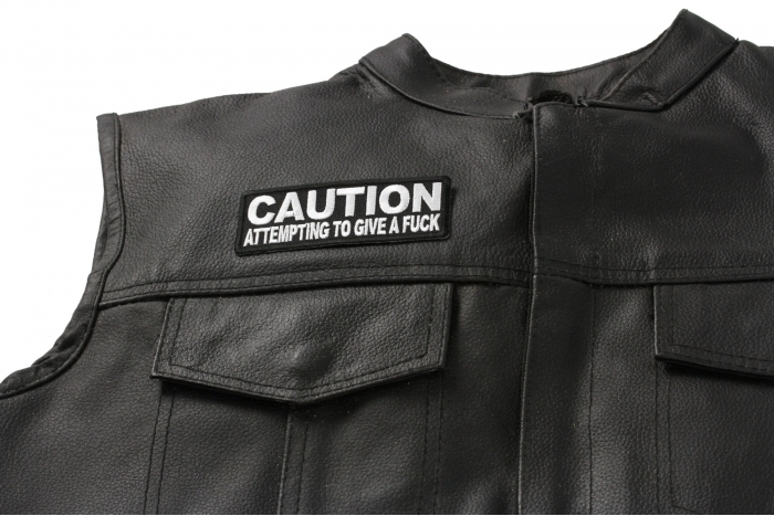 Caution Attempting To Give A Fuck Patch - Iron on Patch - 4x1.5 inch shown on leather vest