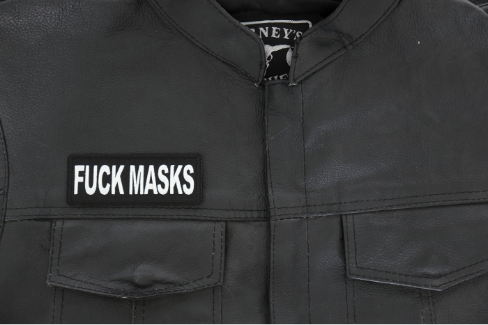 Fuck Masks Patch - 4x1.5 inch - Embroidered Iron on Patch shown on leather vest