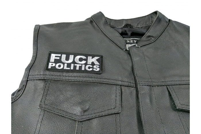 Fuck Politics Patch - 4x1.5 inch. Embroidered Iron on Patch shown on leather vest