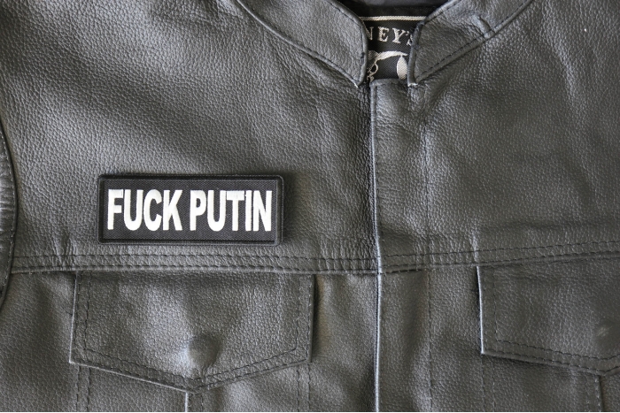 Fuck Putin Patch - 4x1.5 inch - Embroidered Iron on Patch shown on leather vest